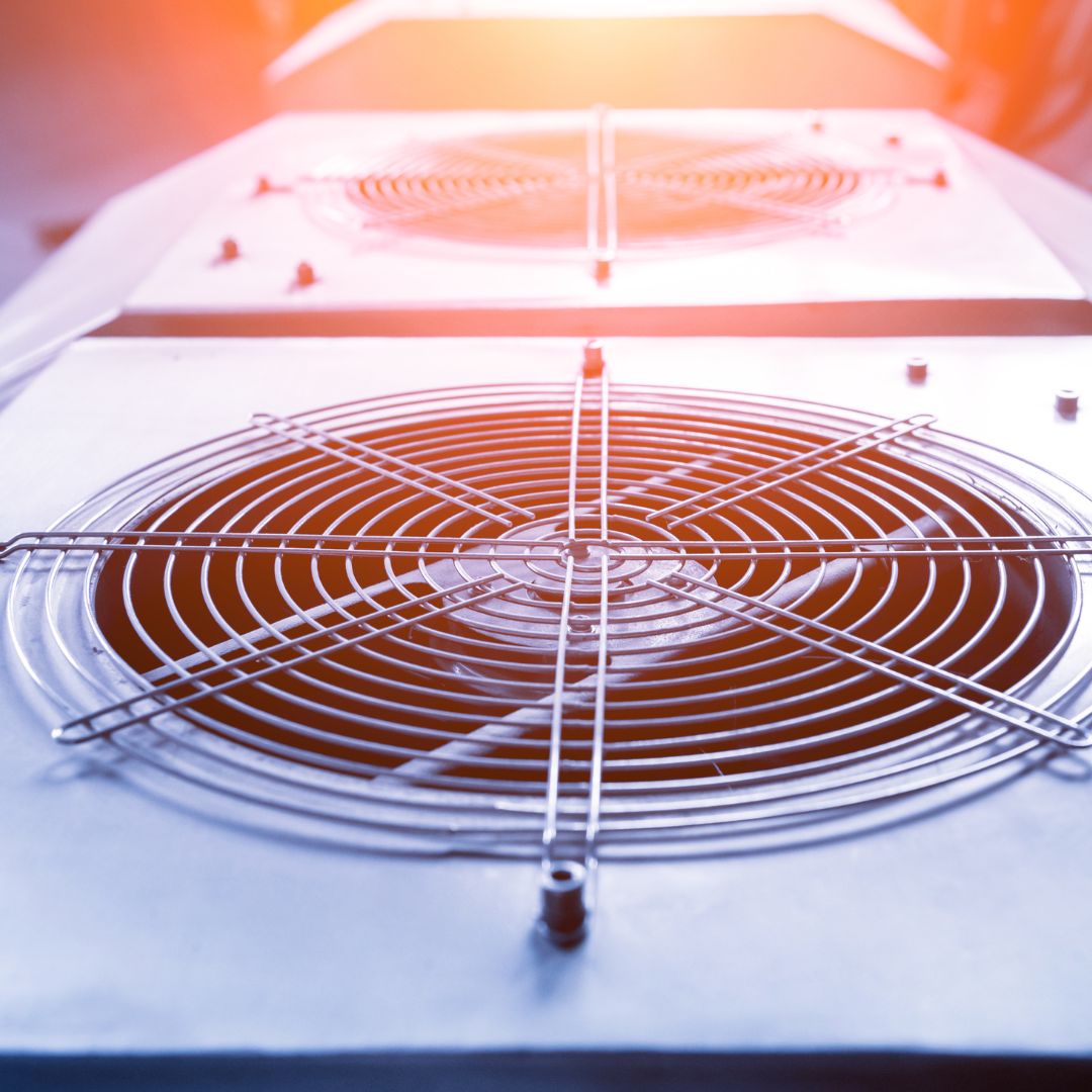 Peak Air HVAC technician servicing an air conditioning unit in an Escondido home, showcasing professional heating and cooling repair and maintenance services.